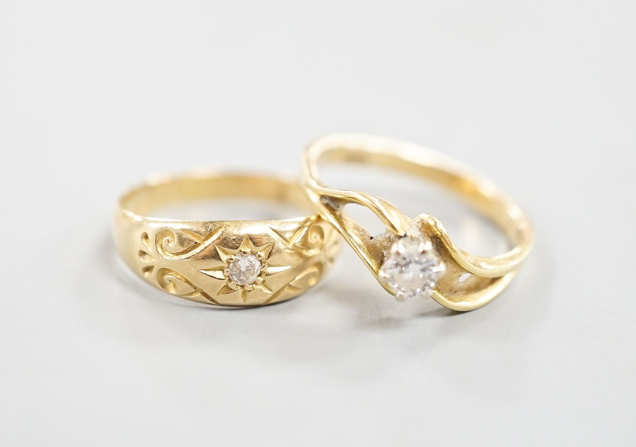 A George V 18ct gold and diamond chip set ring, size O and a later 750 yellow metal and solitaire diamond ring, size P, gross weight 5.9 grams.